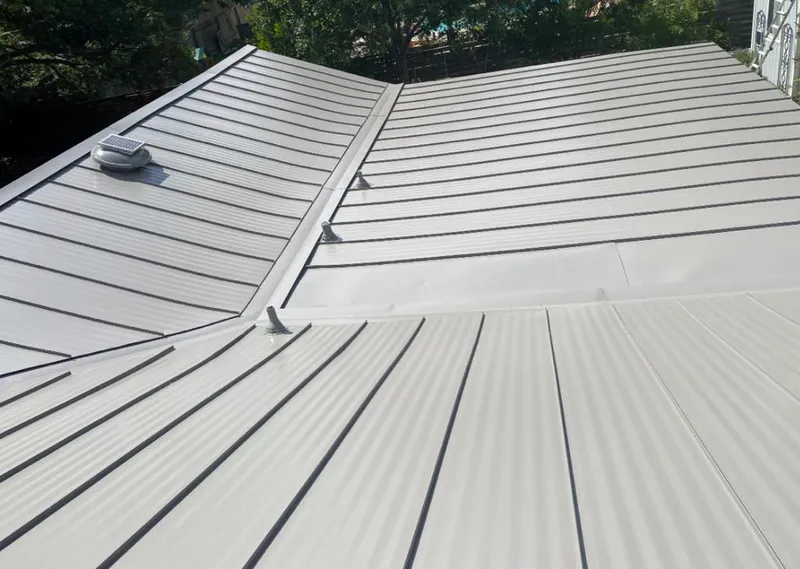Solar attic fan installed on a metal roof for Roof Ventilation in Dillon